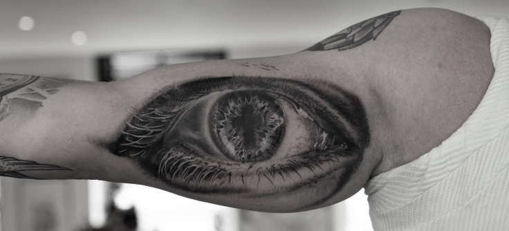 This artistic tattoo combines a realistic eye and graphic of the Eye of  Horus patterns | Ratta Tattoo
